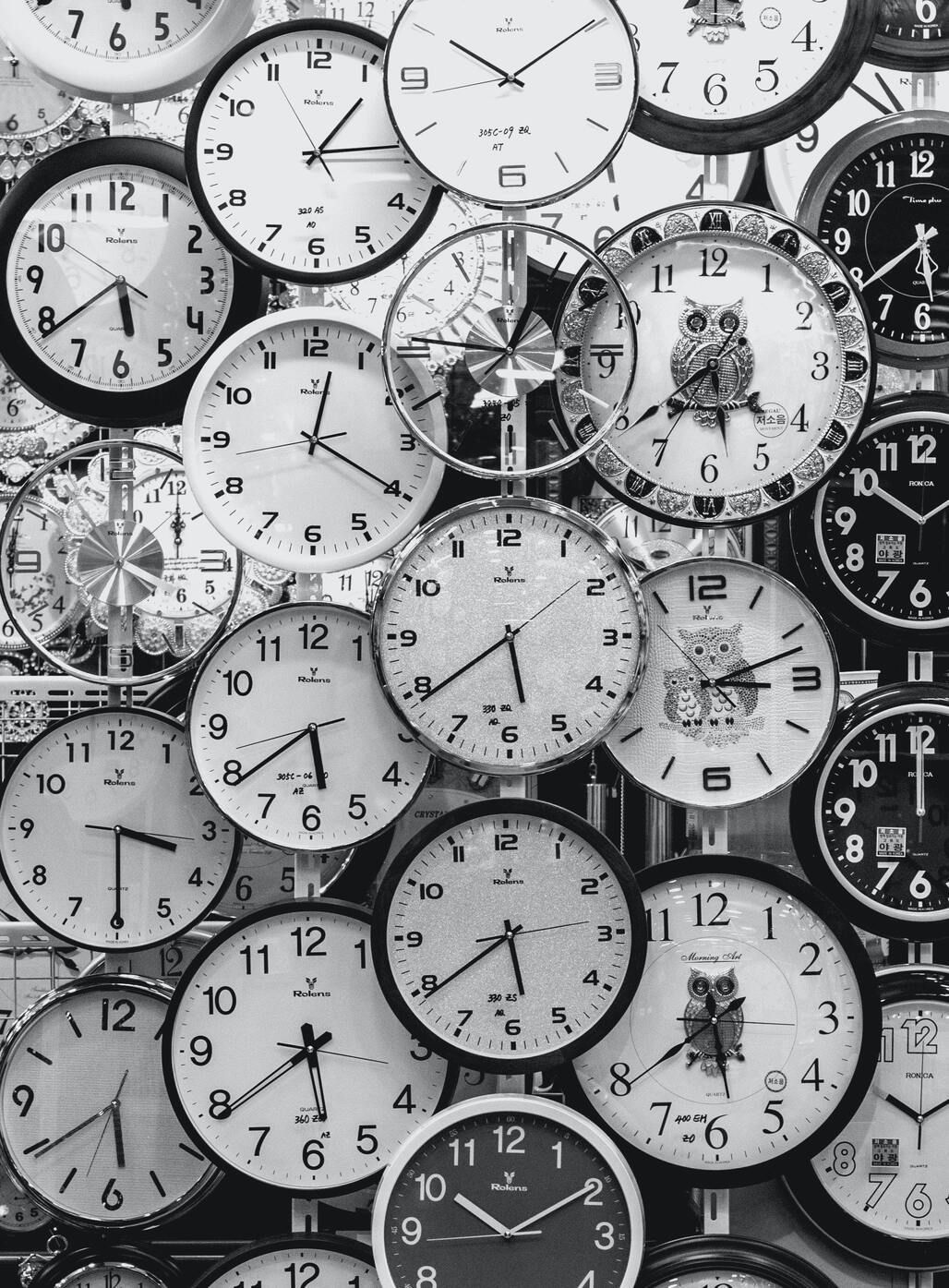 Wide array of black and white clocks indicating time and urgent tasks