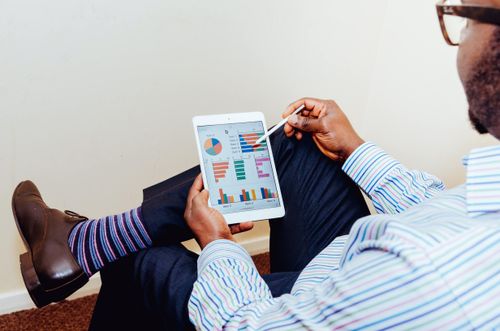 Man looking at financial analytics on a tablet