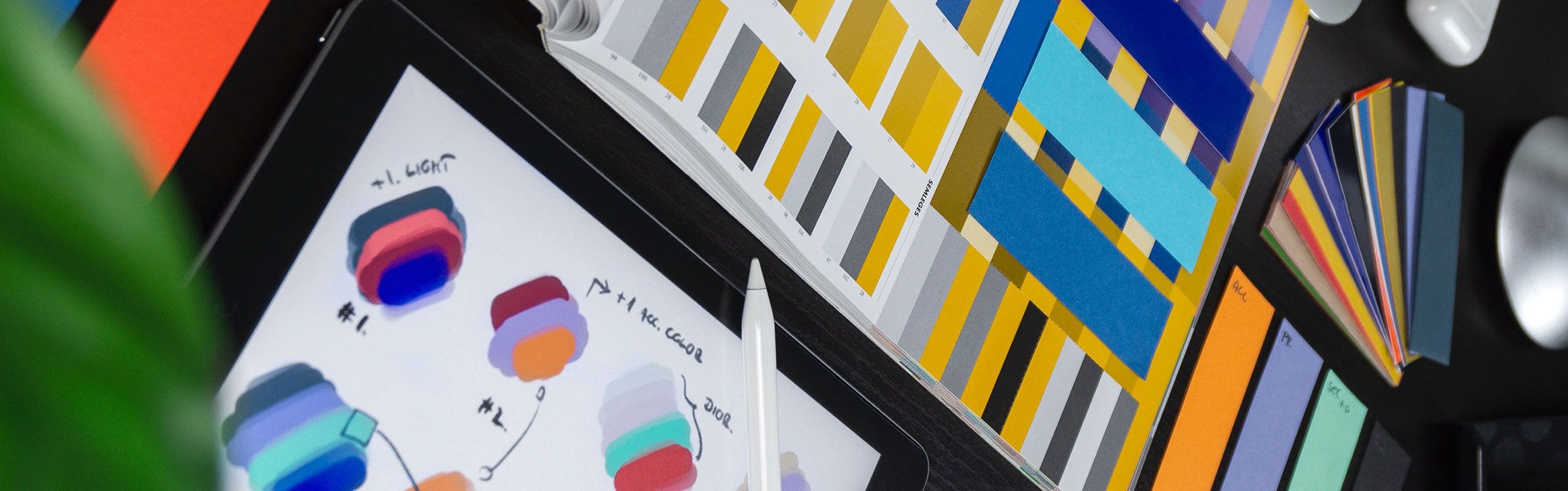 A graphic designer’s workspace featuring sketches and color swatches.