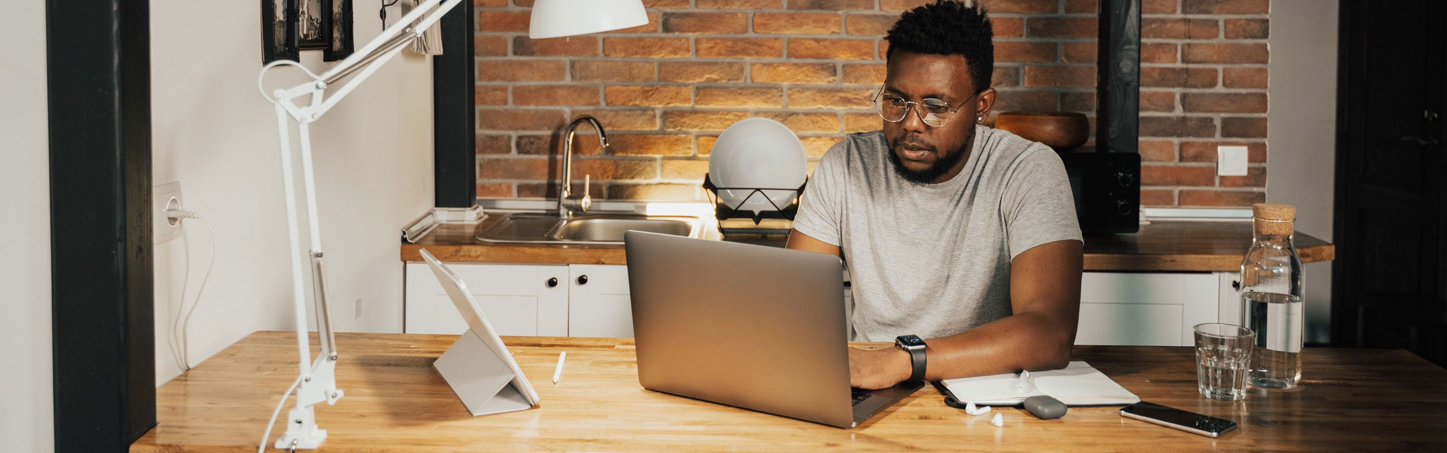 Man sitting in front of computer as he managing multiple projects