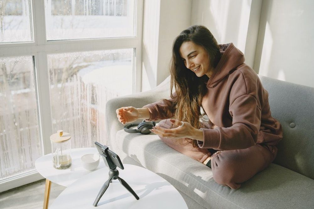 Freelancer woman creating content while sitting on the couch