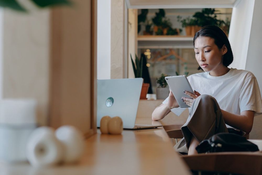 Content creator is sitting with the laptop to know what is the difference between target audience and target market