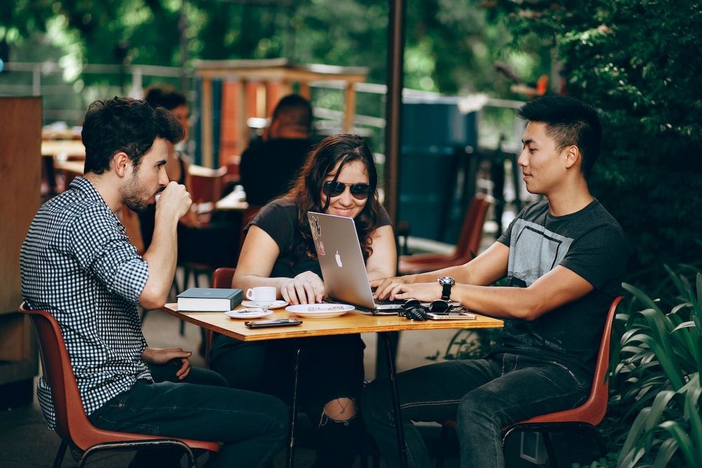 Three freelancers have a meeting at the cafe