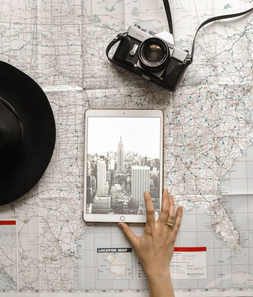 Map and the tablet with the picture of the city to travel