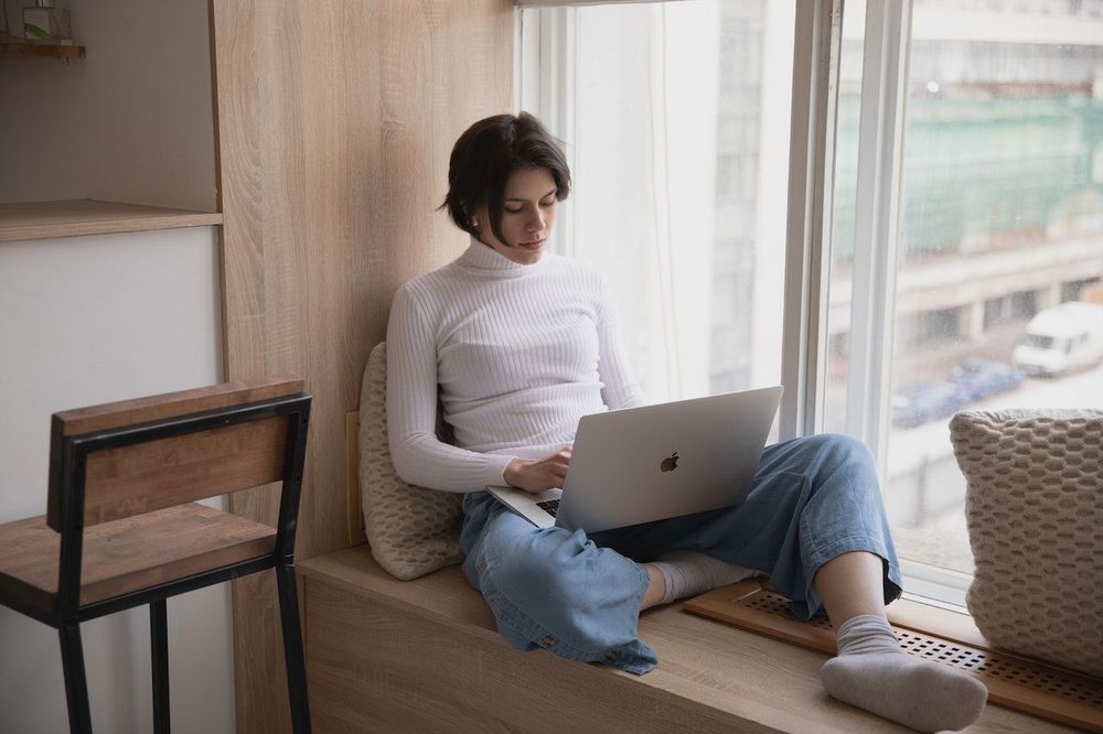 Freelance is working from home sitting on the windowsill