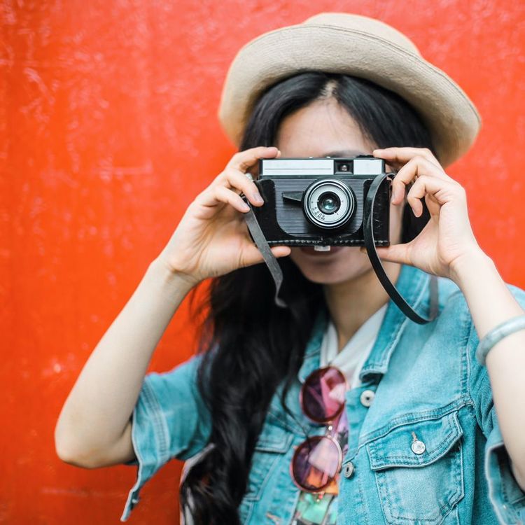 woman taking a photo with camera for her photography proposal