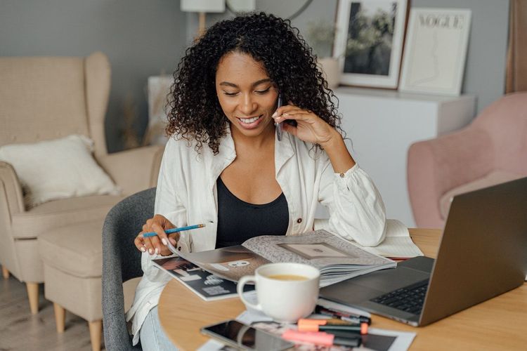 Freelancer working at home and talking on the phone