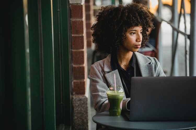 Freelance content creator is sitting and the café and working on content strategy to make out money
