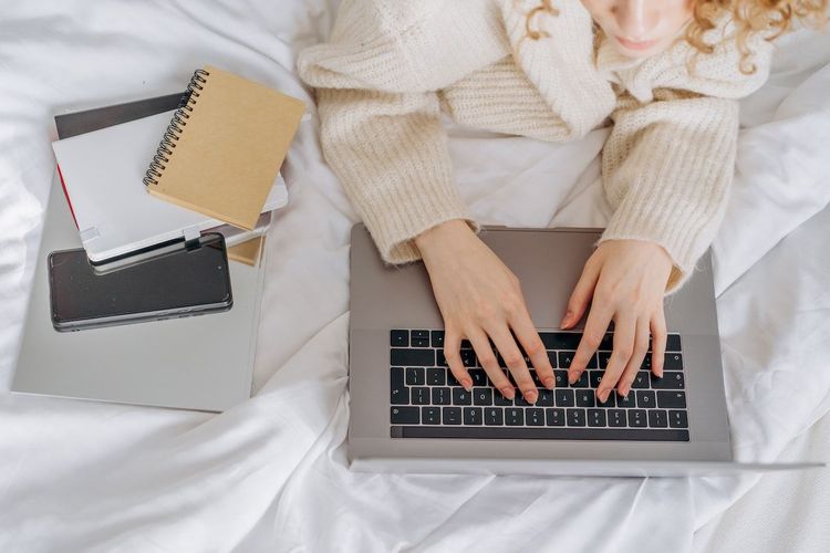 Close-up of hands working with the help of laptop